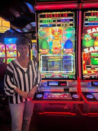 tg7775 slot game interface showing colourful reel titles on mobile
